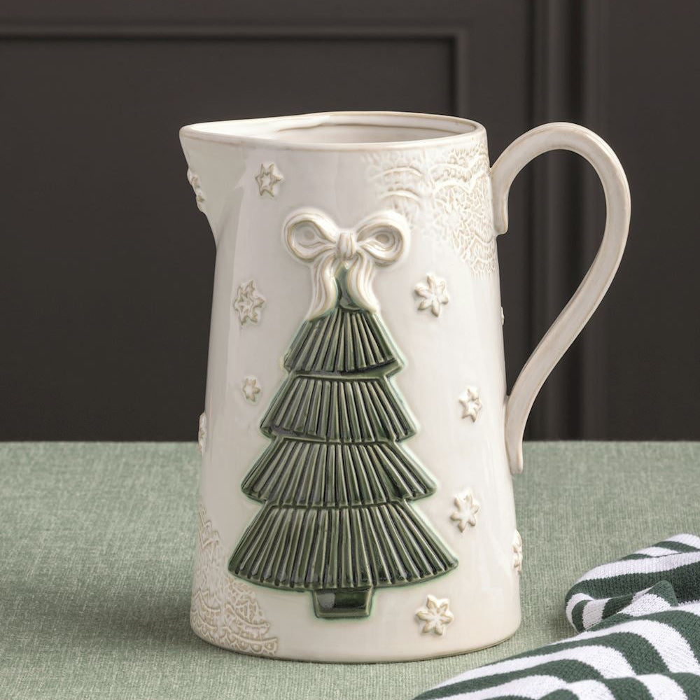 pressed lace tree pitcher on a green table cloth with a kitchen towel draped nearby