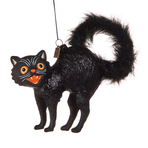 black cat in a scared pose with big orange eyes and furry tail ornament