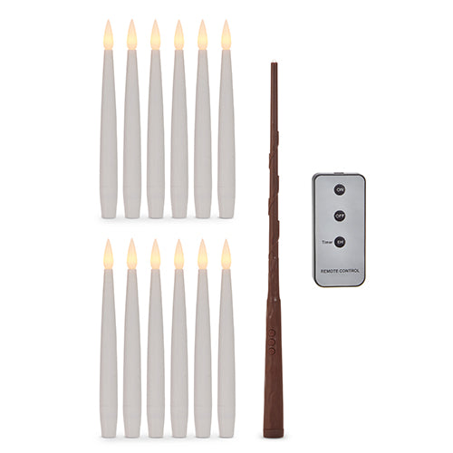 set of magic candles with remote and magic wand arranged on a white background