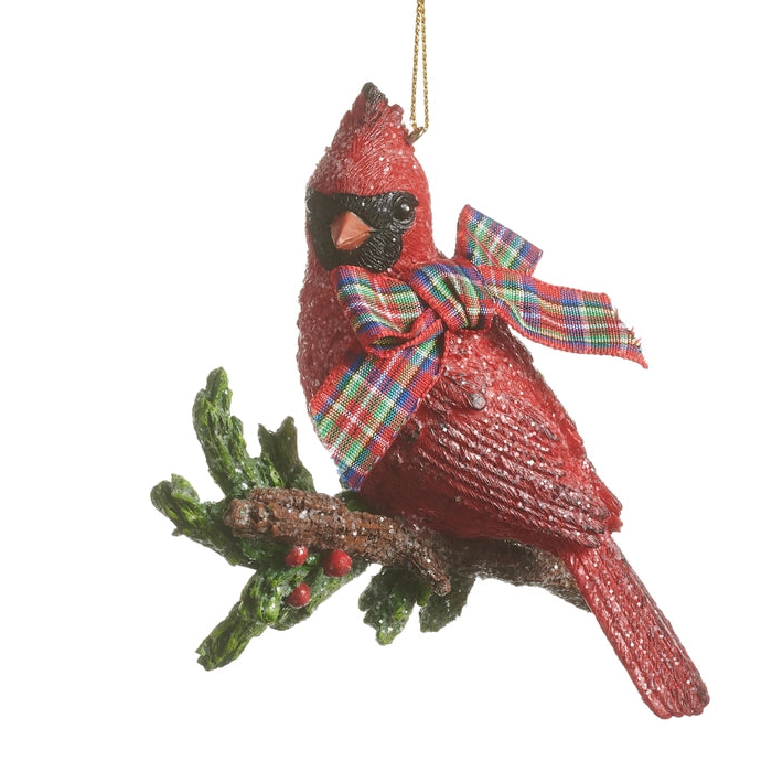 Christmas ornament shaped like a red cardinal perched on holly branch and a red plaid bow on his neck