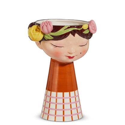 ceramic vase shaped like a girls head with flowers on sides of rim