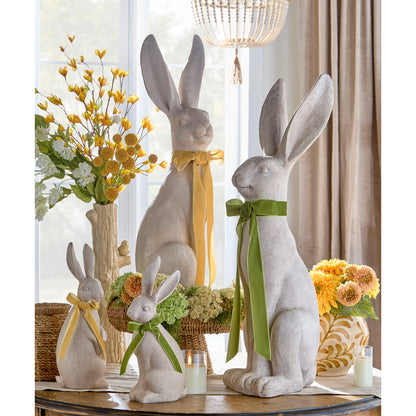 concrete like rabbits with a green and yellow bows in a decorated setting