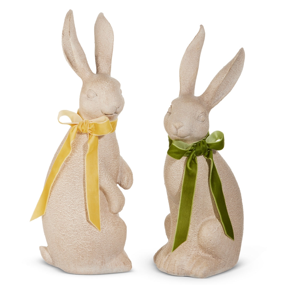 2 concrete like bunnies, one with a yellow bow and one with a green bow