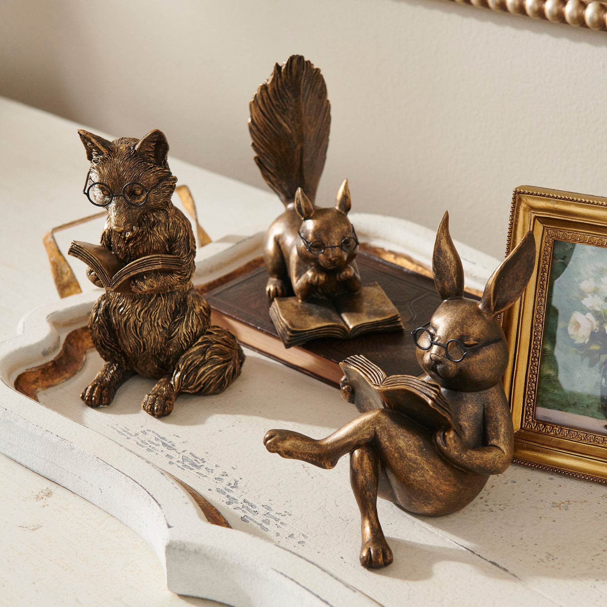 antique gold fox, rabbit, squirrel wearing glasses and reading books in a decorated space