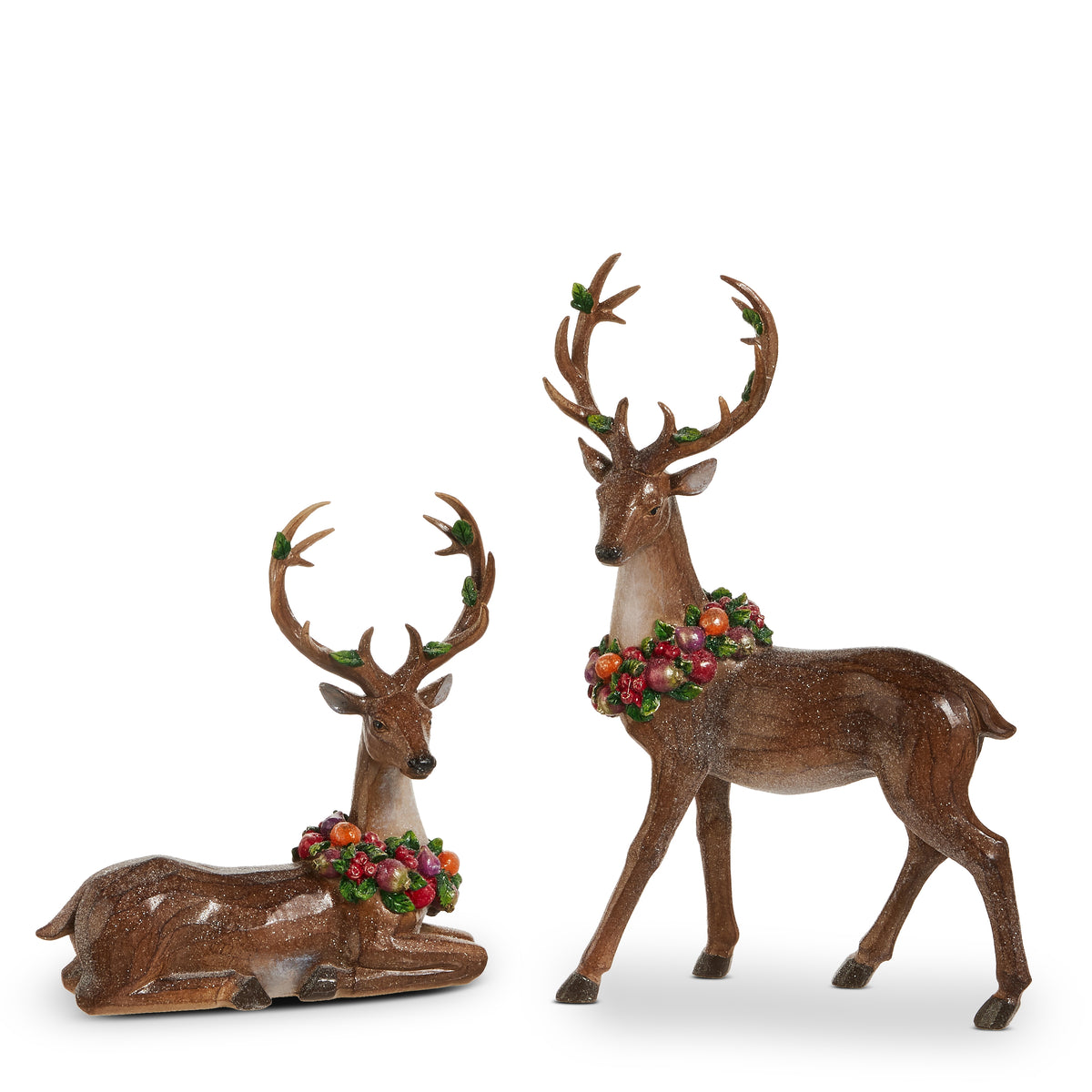 two brown deer figurines wearing fruit wreaths around their necks, one sitting and one standing on a white background