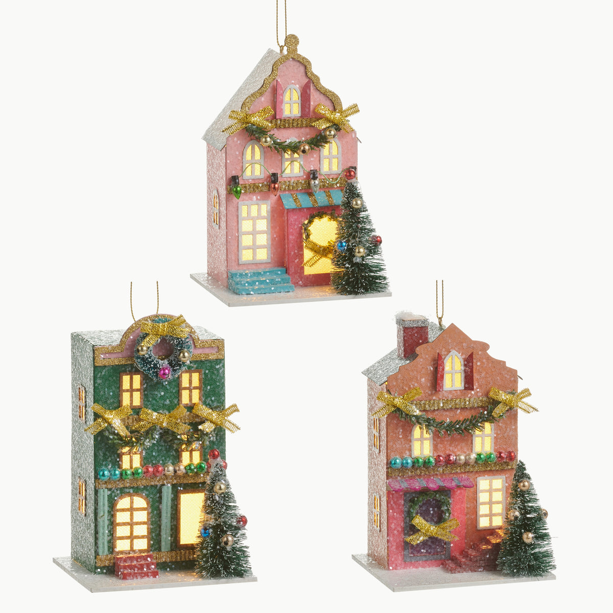 3 light up multicolor house ornaments on a white background