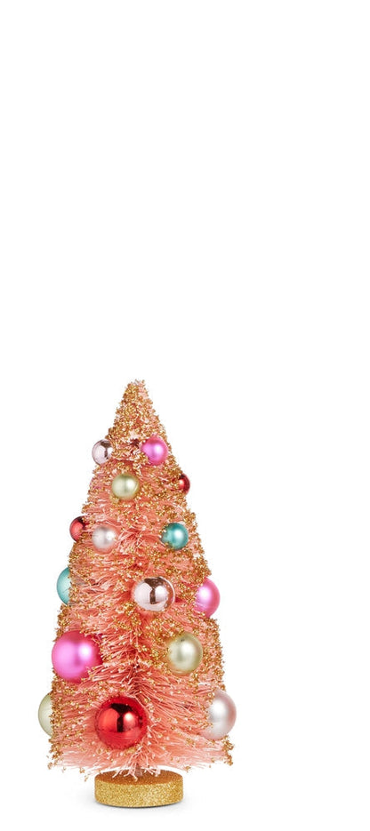 small pink bottle brush trees dusted with gold glitter and embellished with colorful ornaments on a white background
