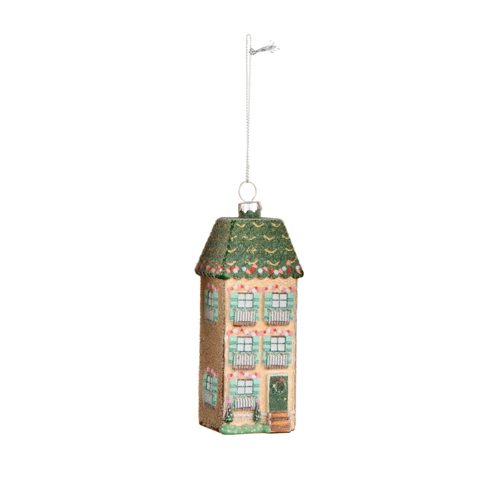 3 story house ornament with candy details, a wreath on the door and green shutters and roof