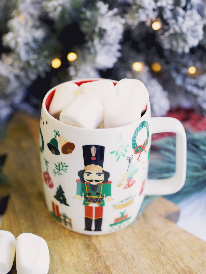 Nutcracker mug set on a table and filled with mashmallows.