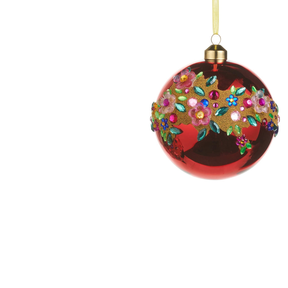 red glass ball ornament with jeweled floral design swirling across it
