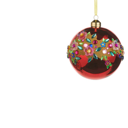 red glass ball ornament with jeweled floral design swirling across it
