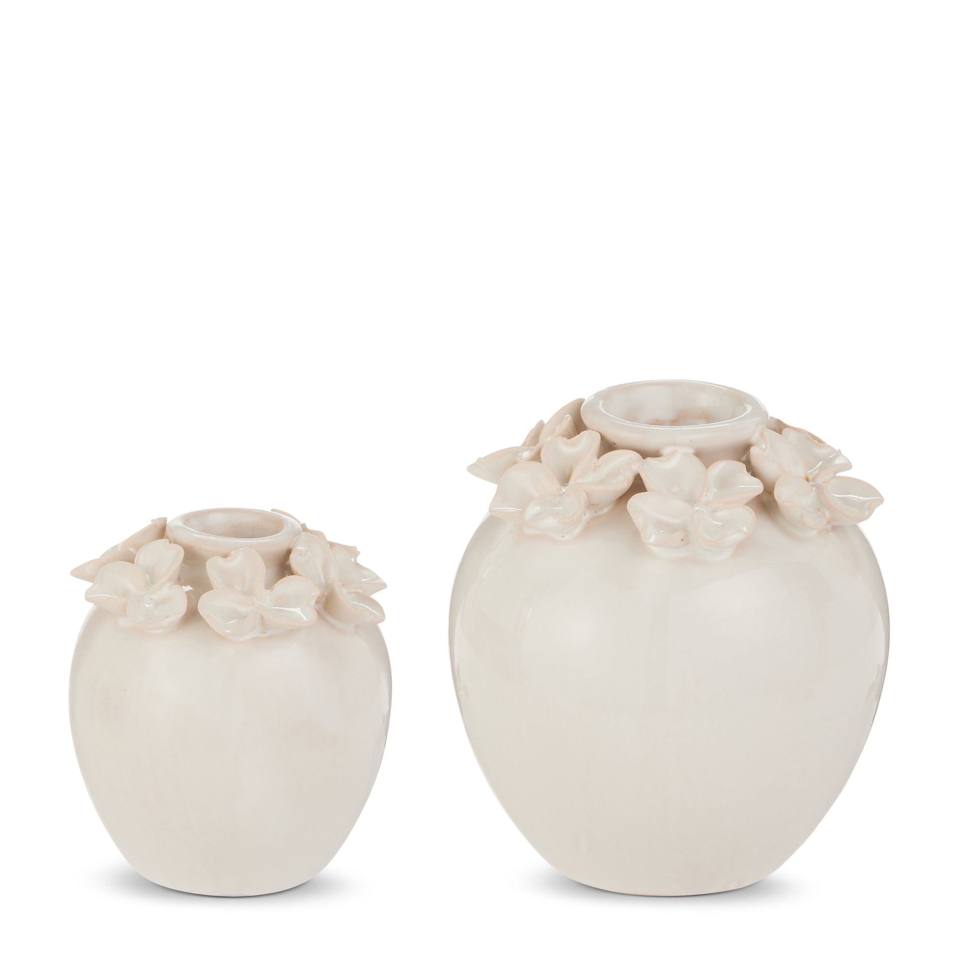 2 white vases with flowers on the rim