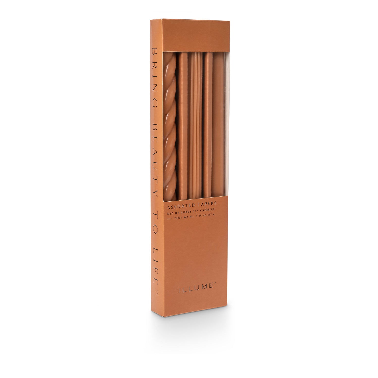 three assorted orange taper candles in their packaging