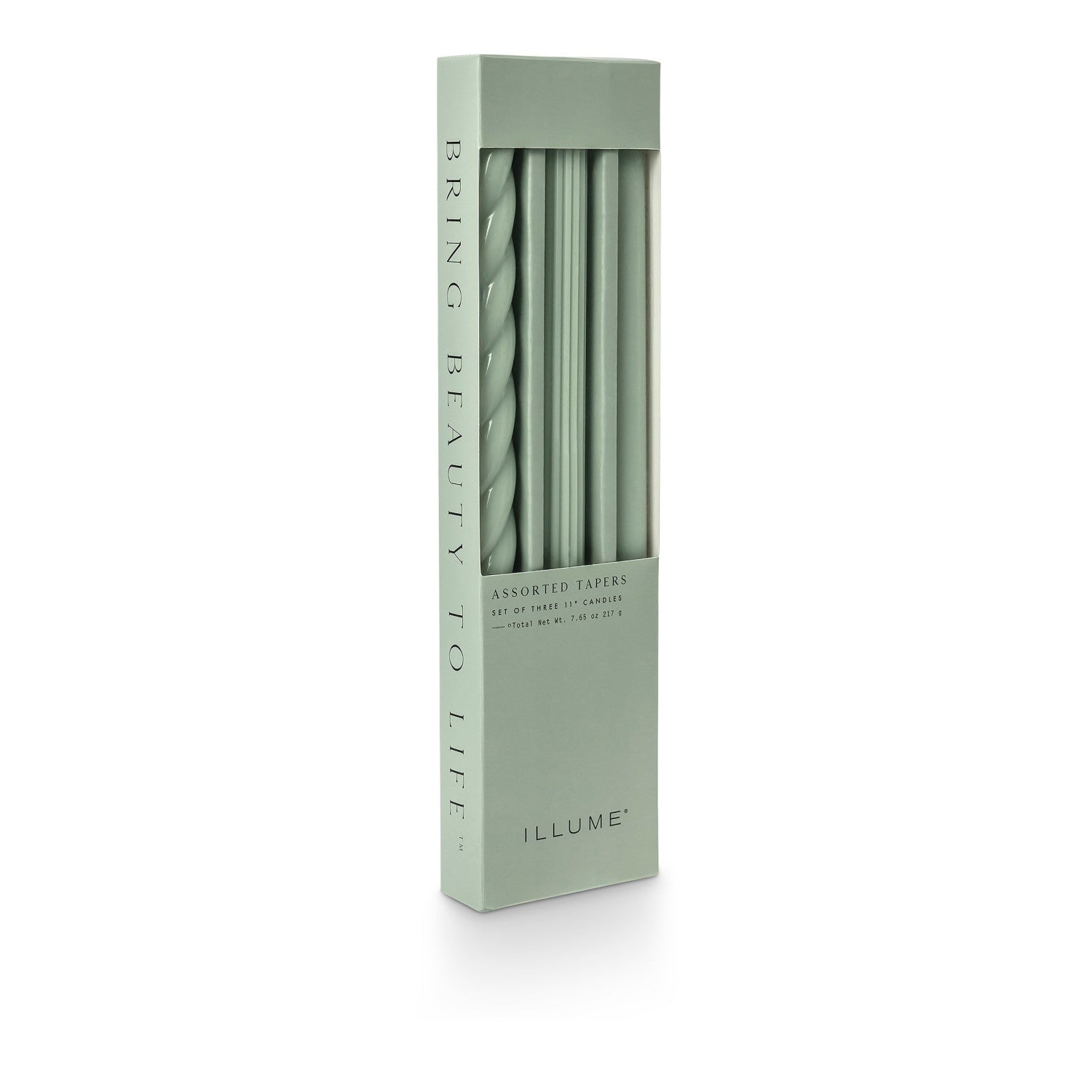 three assorted green taper candles in their packaging