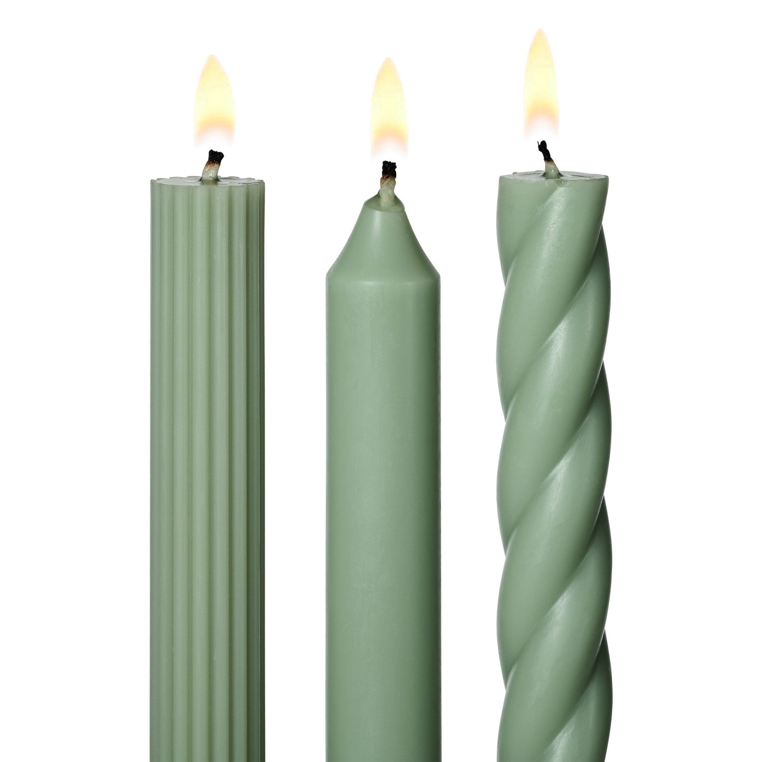 three lit assorted green taper candles on a white background
