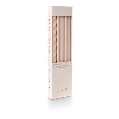 three assorted blush taper candles in their packaging