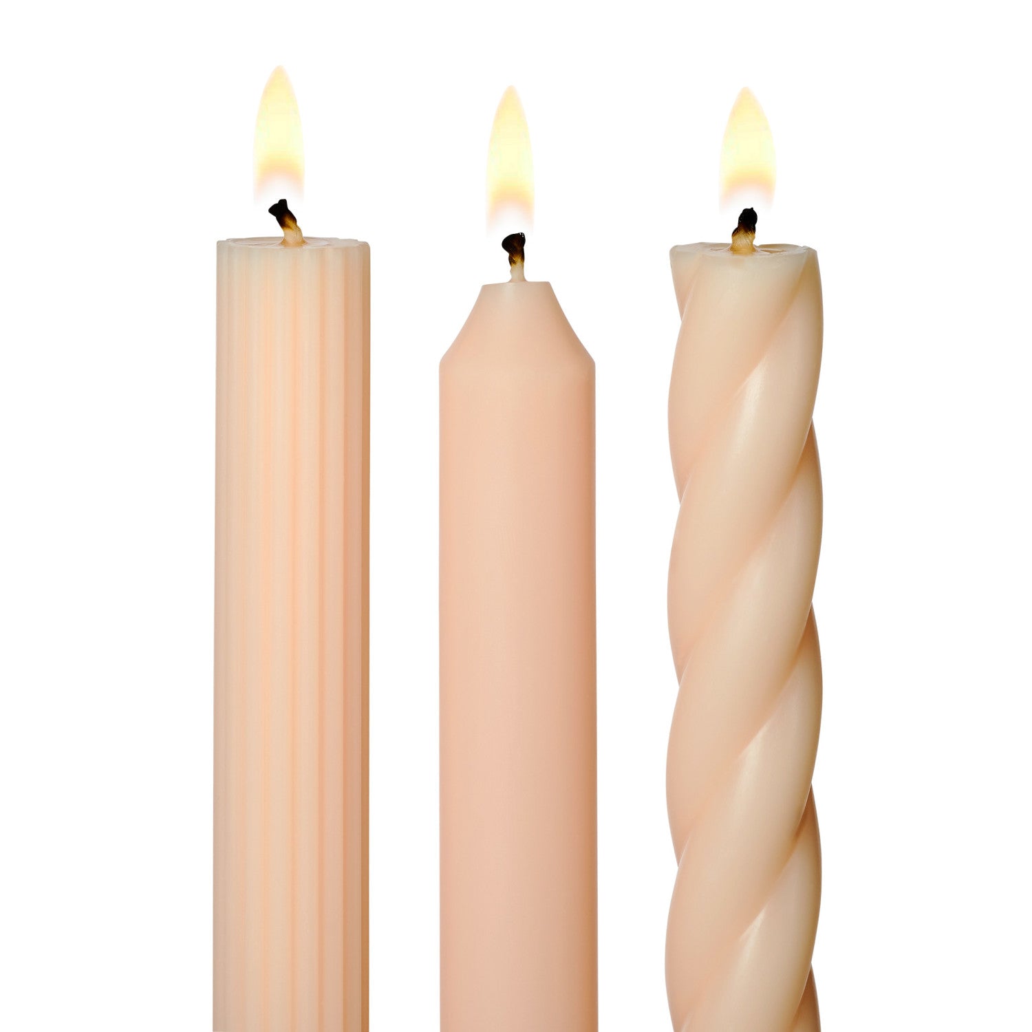 three lit assorted blush taper candles on a white background