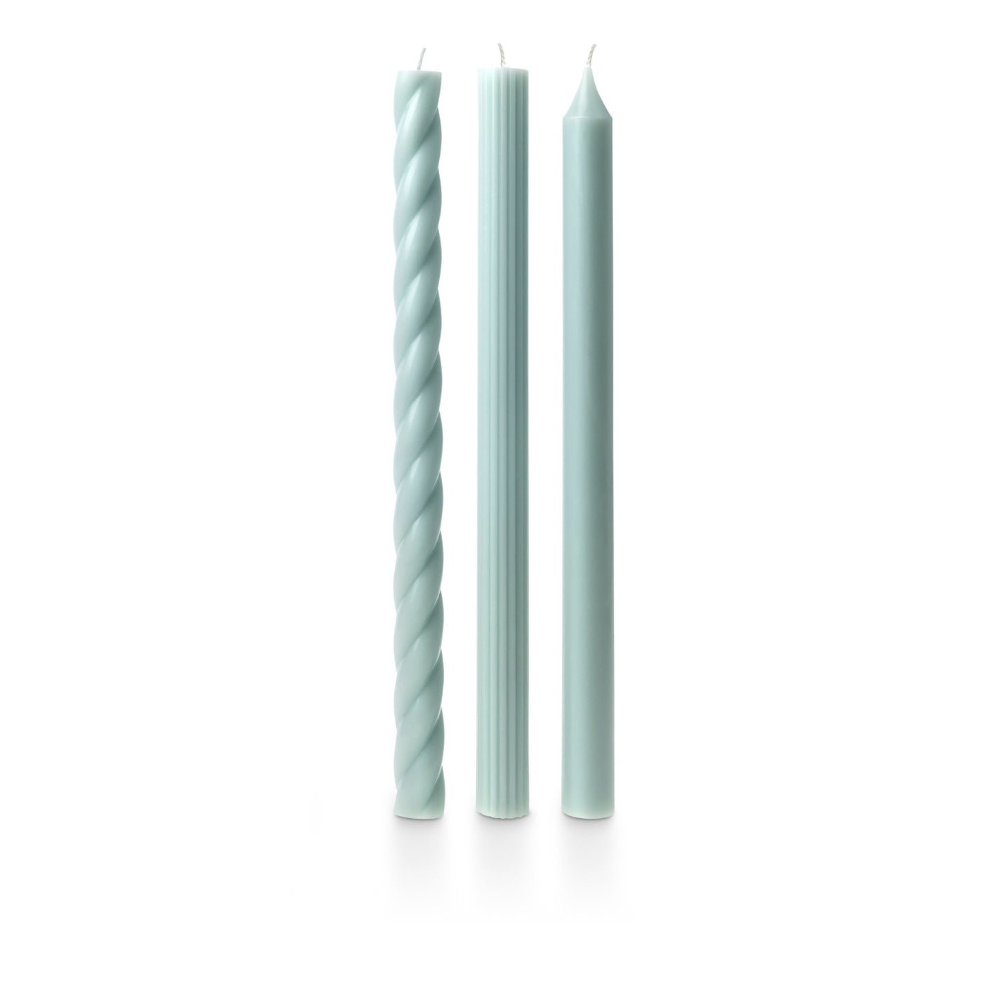 three assorted light blue taper candles on a white background