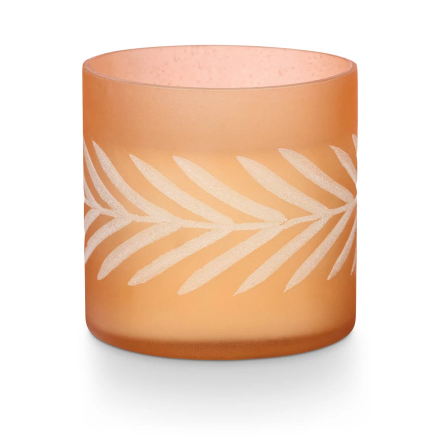 side view of pumpkin candle in frosted glass jar