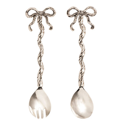 Two silver serving utensils with decorative bows on a white background