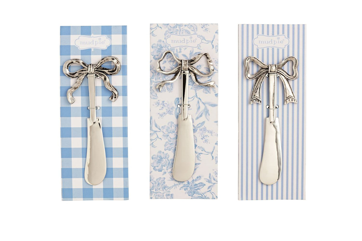 3 spreaders with bow handles on decorative cards in a row