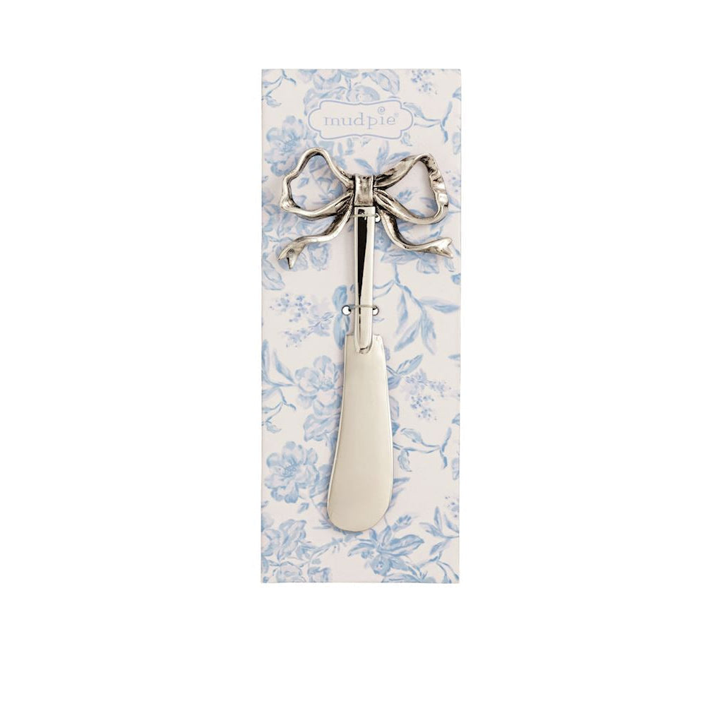 spreader with bow handle tied on a blue toile card