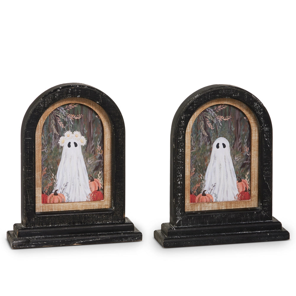 Two styles of Halloween art in black arched frames featuring a ghost and pumpkins