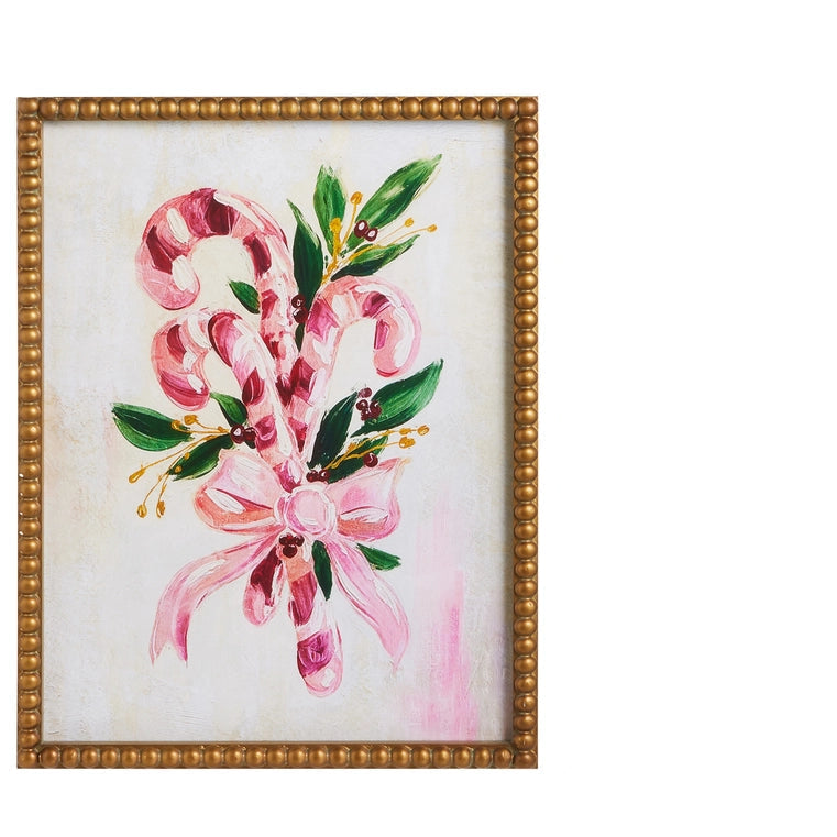 gold framed christmas art of 3 candy canes and sprigs of evergreen ties with floppy pink bow