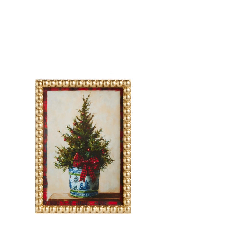 A framed art print of a potted Christmas tree with a red bow, set in a gold beaded frame against a white background.