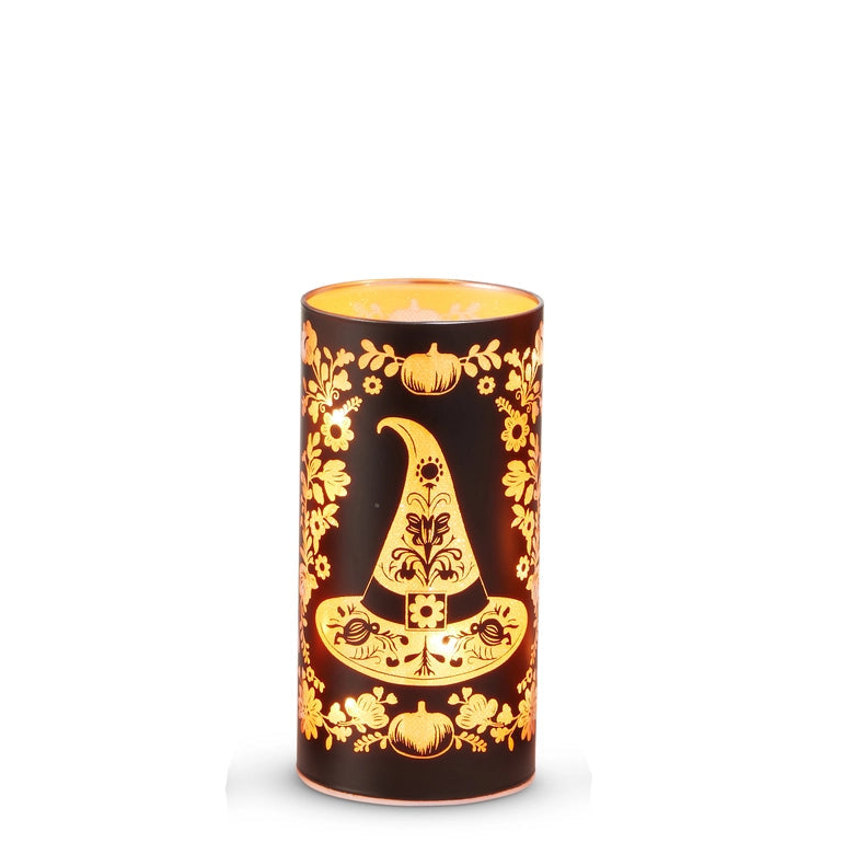 medium round black glass lantern with illuminated design of a witches hat, small pumpkins, and flowers 