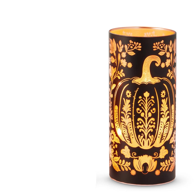 large round black glass lantern with illuminated design of a pumpkin and flowers 