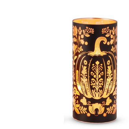 large round black glass lantern with illuminated design of a pumpkin and flowers 