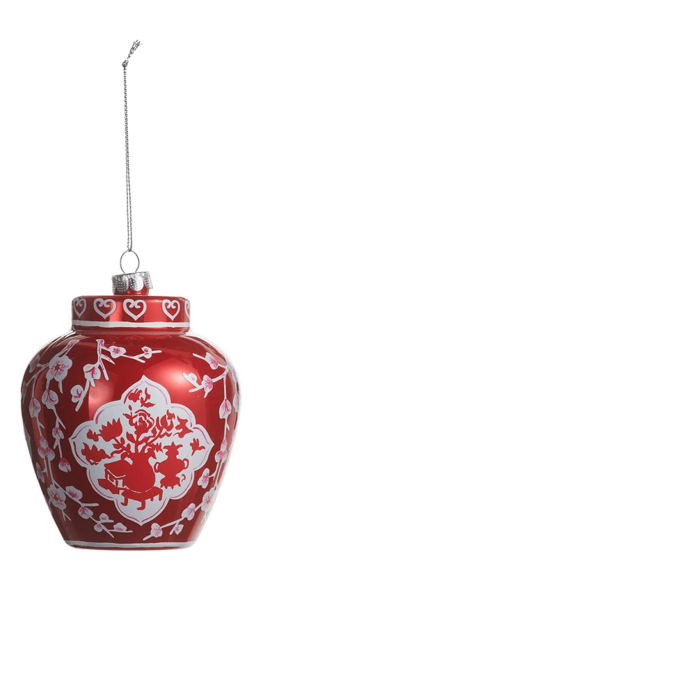 red glass ornament shaped like a ginger jar with white design on it