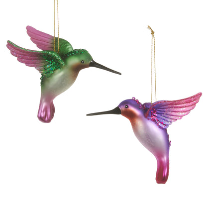 two hummingbird ornaments, one pink and one green on a white background