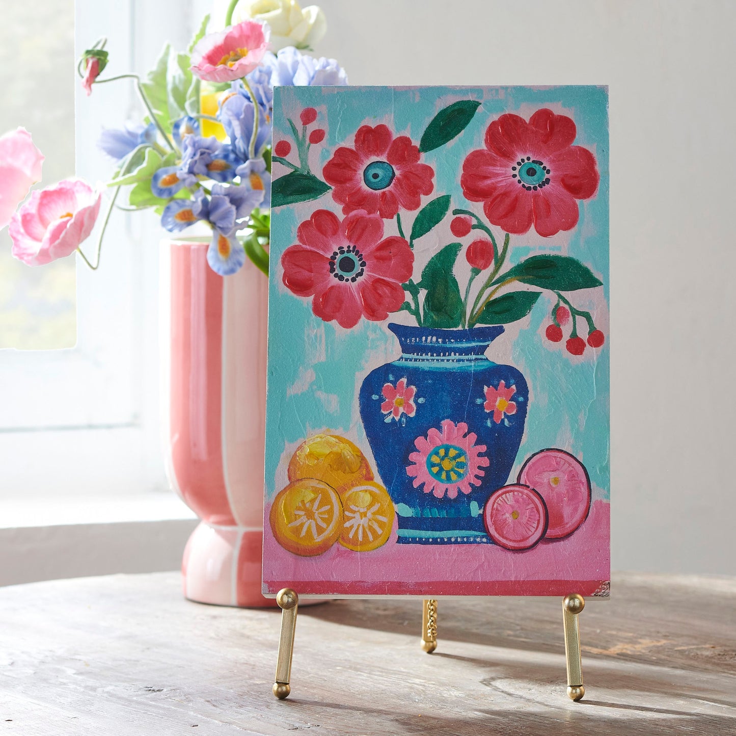 art of vase filled with flowers and fruit at the base of the vase