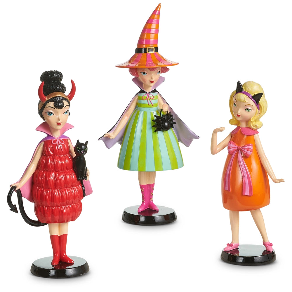 Three witch figurines dressed sassy, colorful outfits