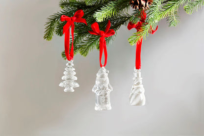 3 styles of glass ornaments hanging from a sprig of greenery.