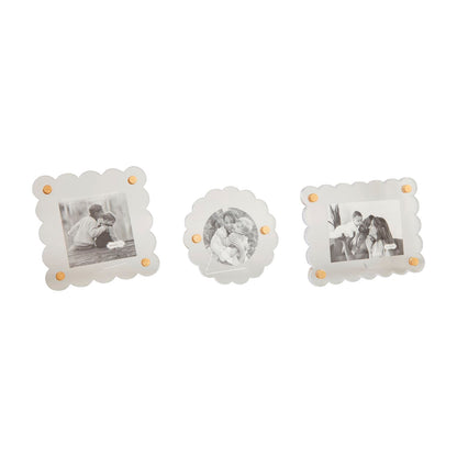 3 assorted acrylic photo frames in a row on a white background