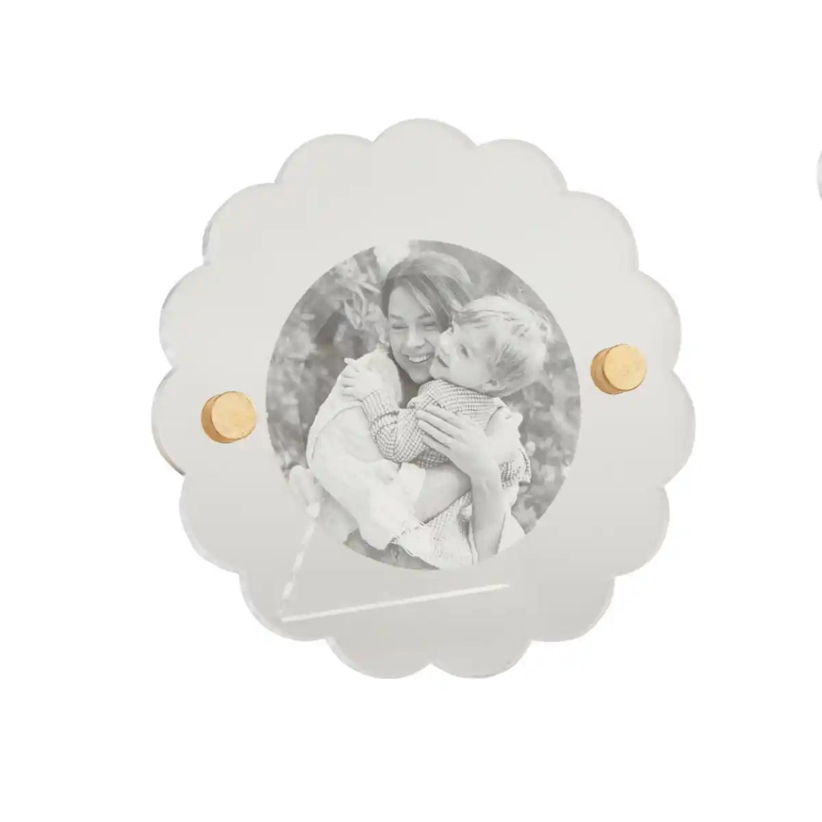 round acrylic photo frame with black and white image of a person holding a child in it