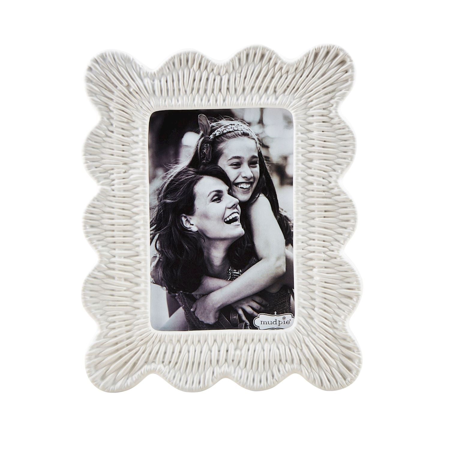 small ceramic photo frame with woven texture, scalloped edge, and black and white image in it.