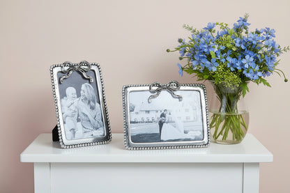 two metal frames with a bow at the top center