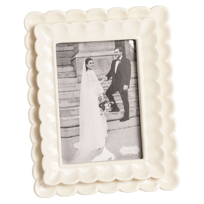 large White decorative photo frame with a black and white photo of a couple on a staircase.