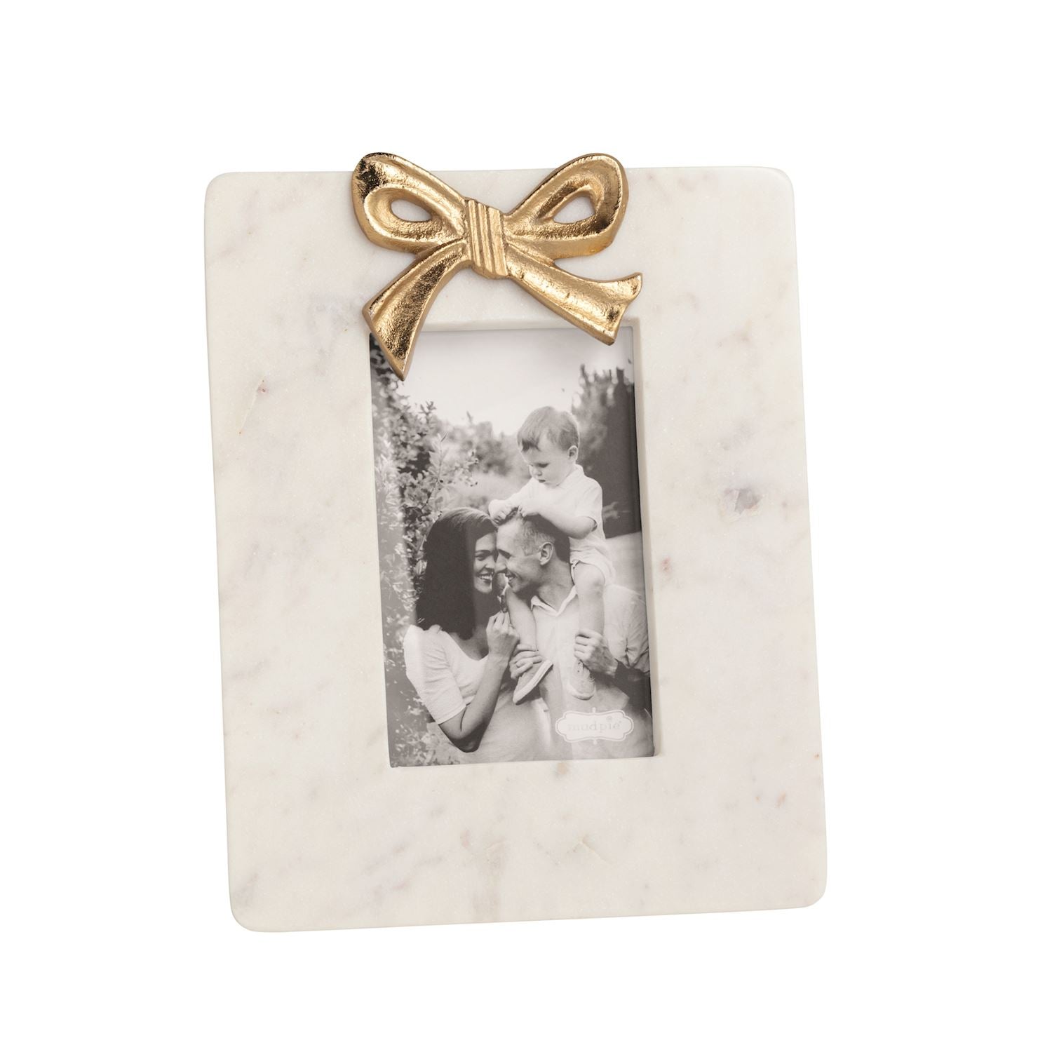 small white marble frame with gold bow and black and white picture in it