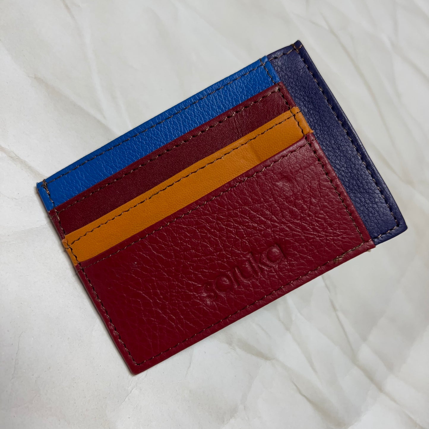 burgundy polly wallet with colorful card slots.