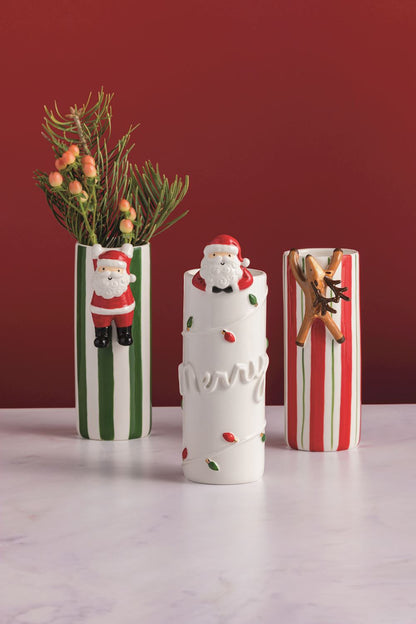 Three decorative vases with Christmas-themed designs on a white surface against a red background.