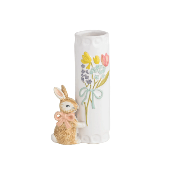 white vase with flower bundle design on it and a little brown bunny attached to the bottom wearing pink bow around its neck