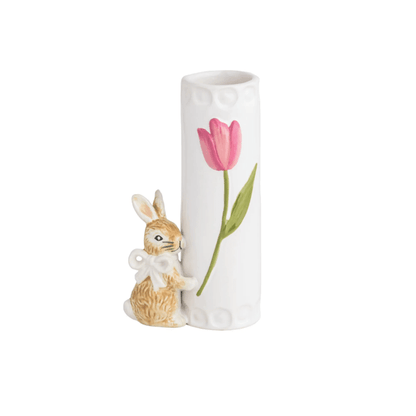 white vase with pink flower design on it and a little brown bunny attached to the bottom wearing white bow around its neck
