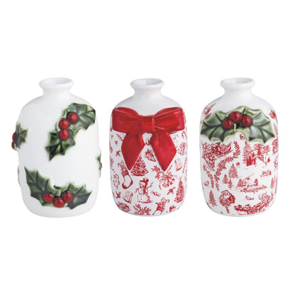  3 white vases with holly or toile designs in a row on a white background