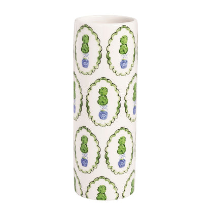 Cylindrical vase with decorative green and blue topiary patterns on a white background