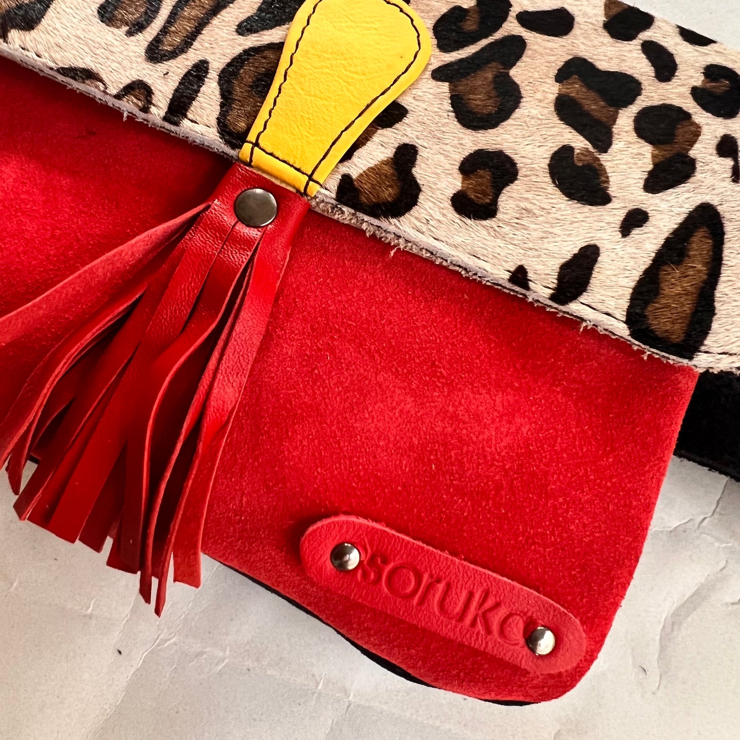 close up of corner of juliette bag with patch stamped with "soruka" logo.